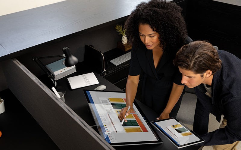 Male and female using Surface Studio 2