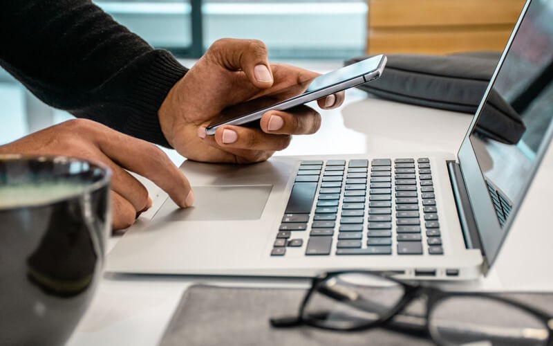 Close up of man using multiple devices