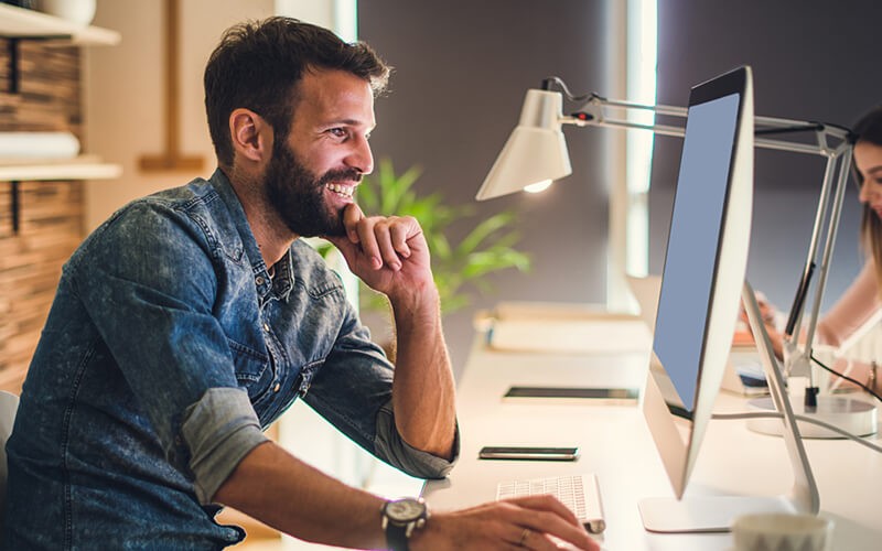 Businessman smiling on computer