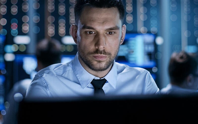 Business man looking over monitor