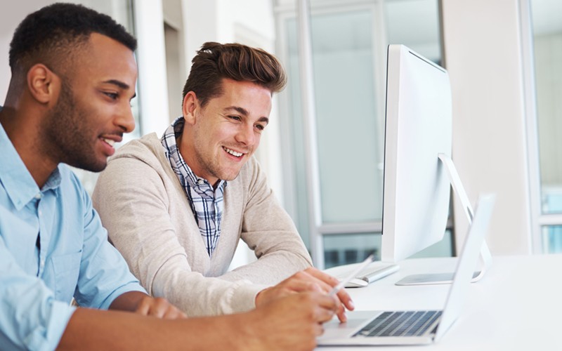Business professionals brainstorming ideas on desktop computer
